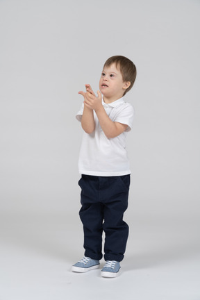 Little boy in casual clothes holding his hand