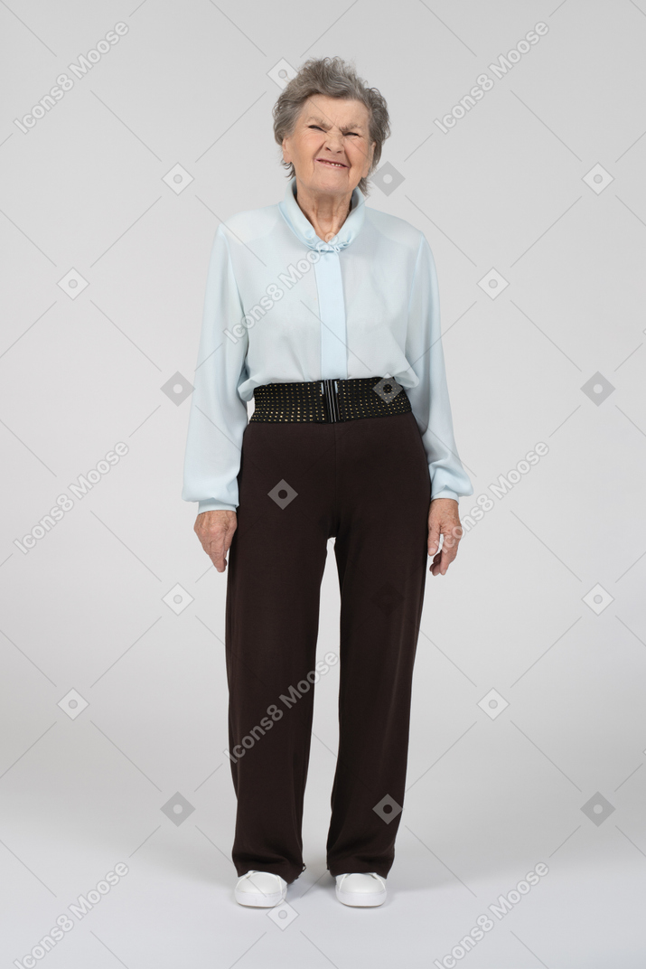 Front view of an old woman wrinkling her face appallingly