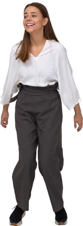 Front view of a jumping smiling young lady in office clothing