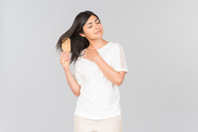 Young indian woman brushing her hair