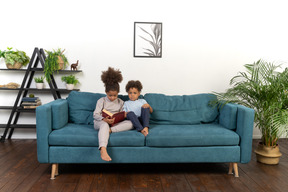 Cute boy and girl reading the book