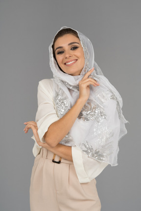 Beautiful woman with radiant smile posing in white shawl