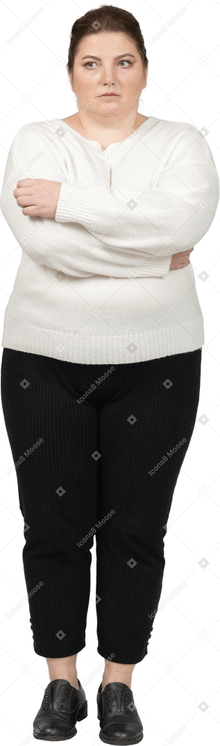 Plump woman in casual clothes keeping arms crossed