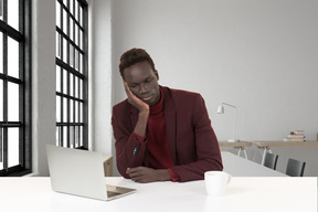 A man sitting in front of a laptop computer