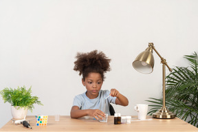 Good looking cute girl doing science at the table