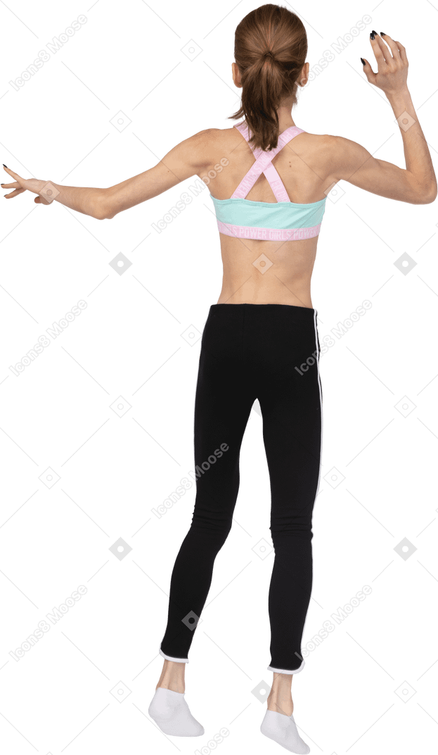 Вид сзади девушки-подростка в спортивной одежде прыгает и машет рукой
