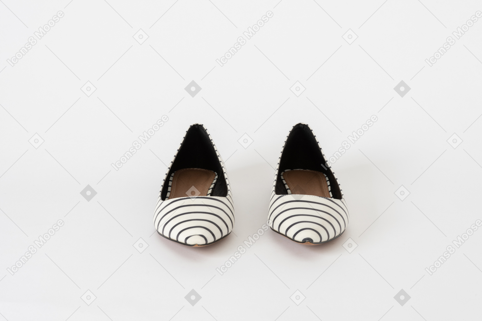 A front shot of a pair of a pair of striped flat black and white shoes
