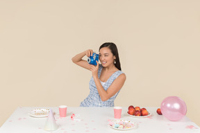 Young asian woman celebrating birthday and making a photo