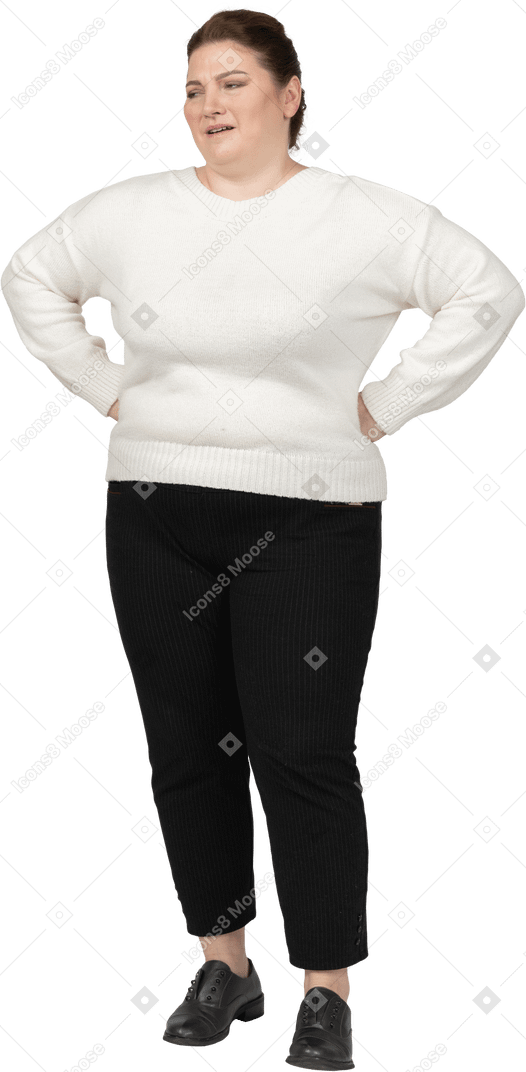 Plump woman in casual clothes standing with hands on hips