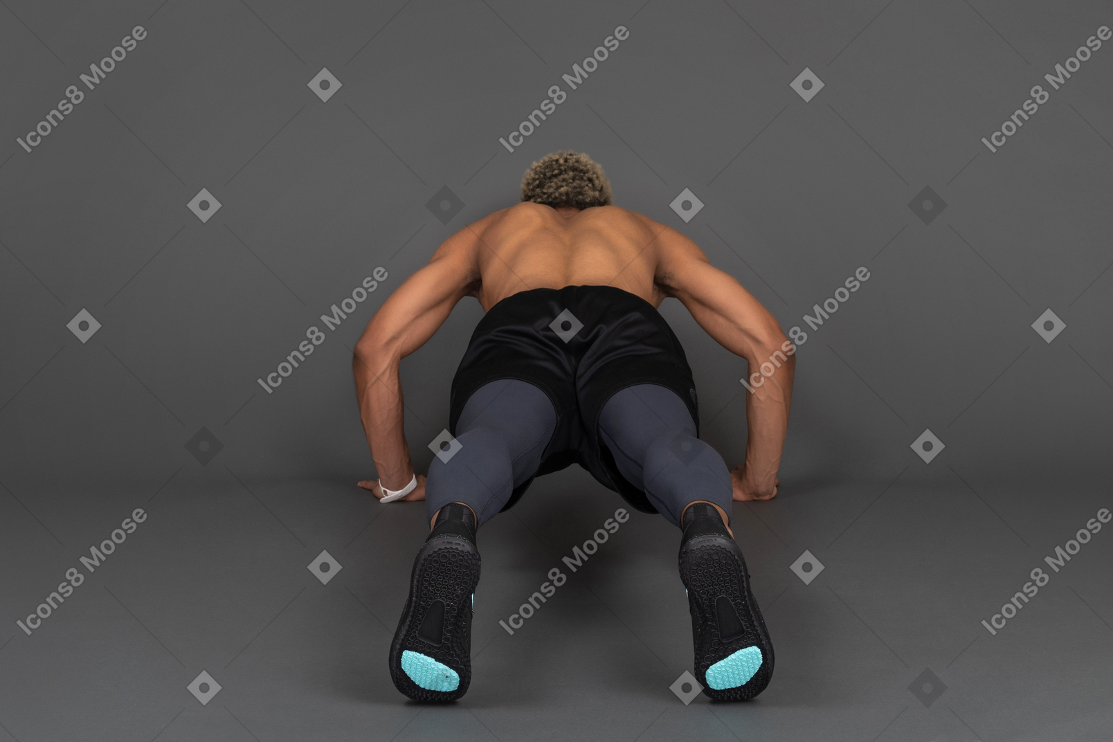 Back view of a shirtless afro man making push-ups