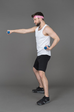 Man exercising with blue dumbbells