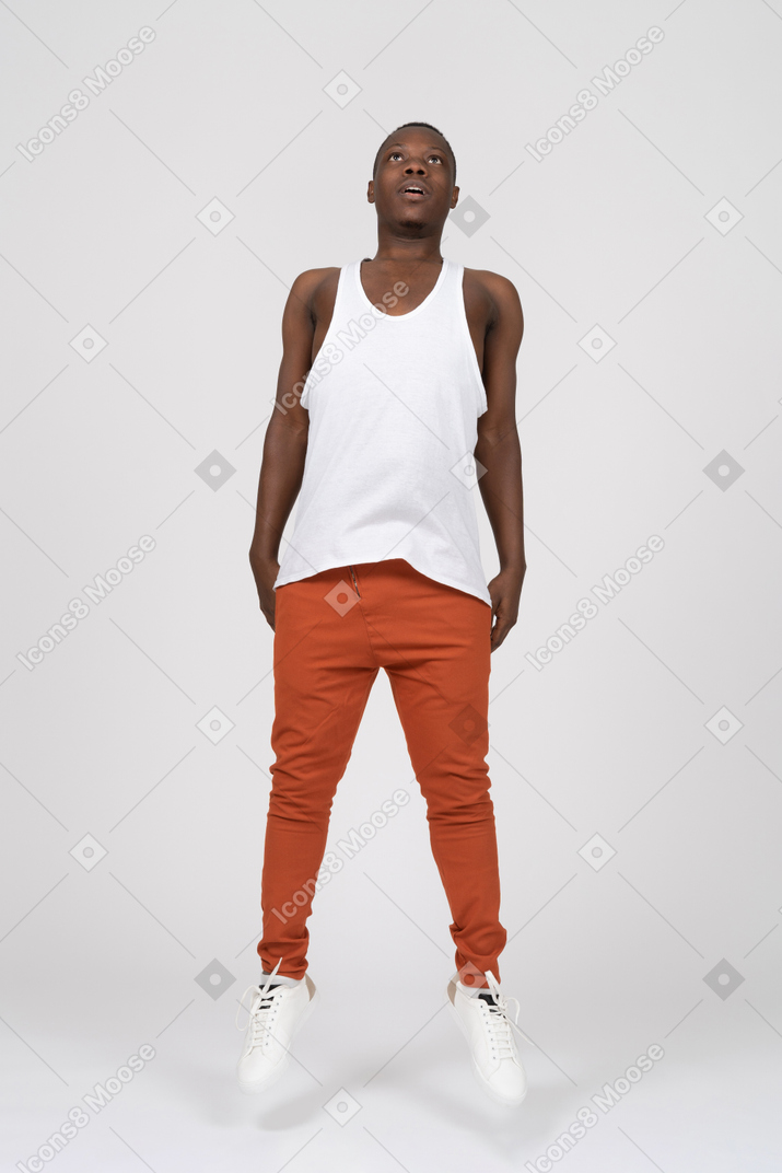 Young man looking up and levitating