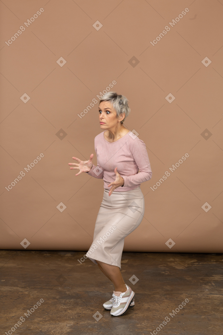Scared woman in casual clothes posing in profile