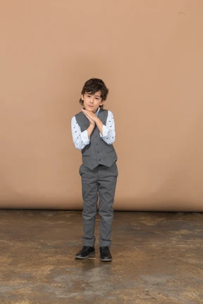 Front view of a cute boy in grey suit