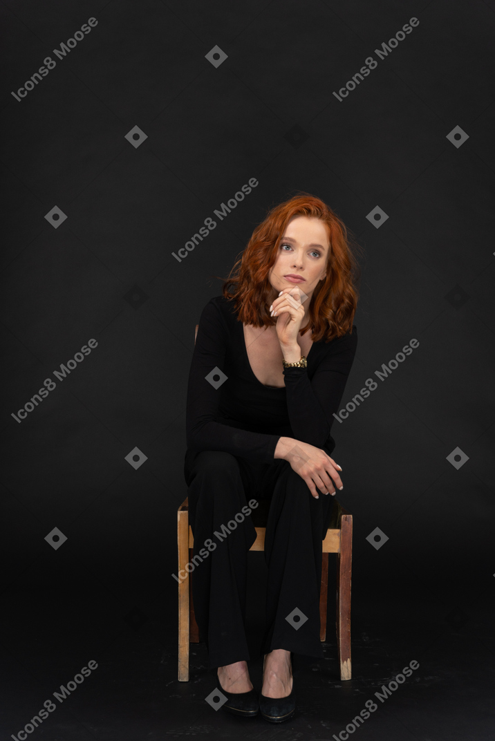 Thoughtful woman sitting on a chair