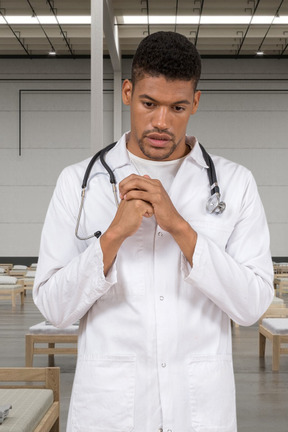 A man wearing a white lab coat and a stethoscope