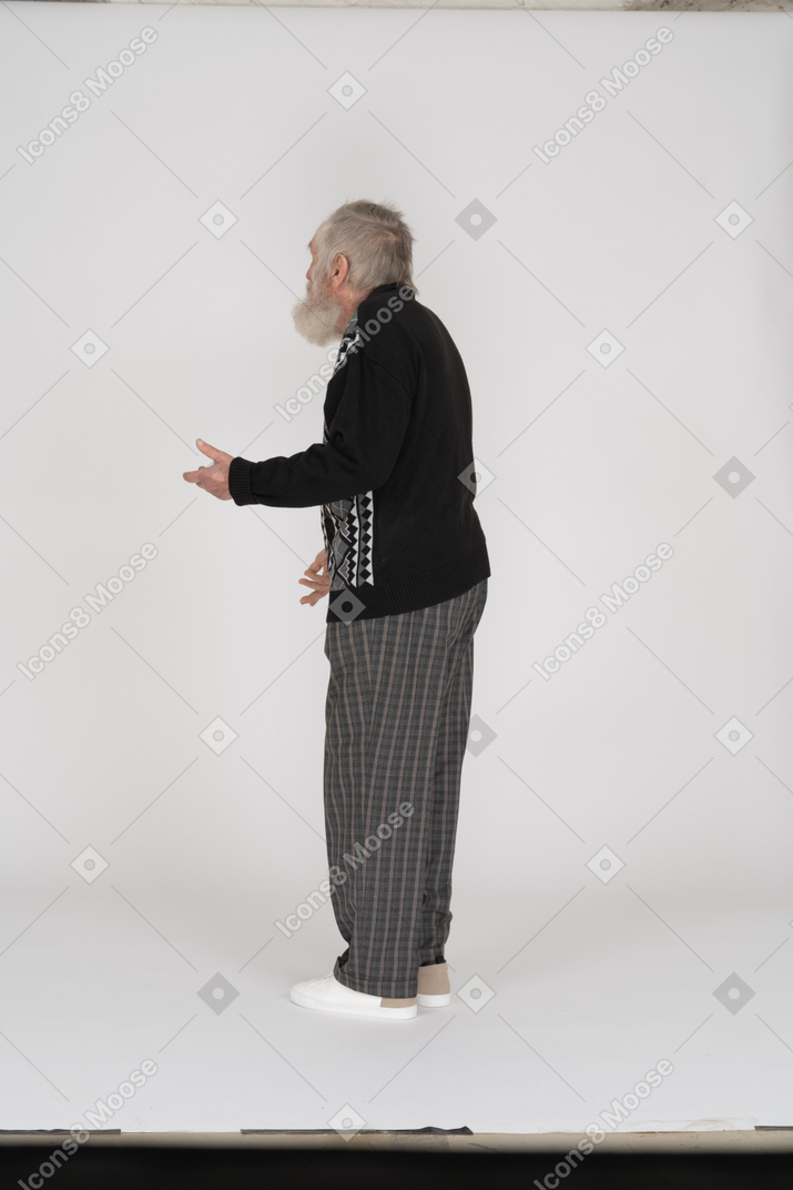 Three quarter back view of old man gesturing
