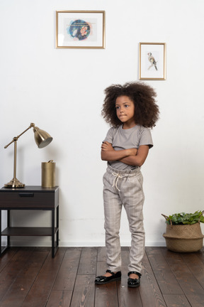 Good looking girl kid posing on the apartment background