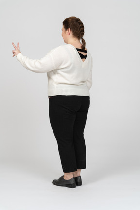 Plump woman in casual clothes standing in profile