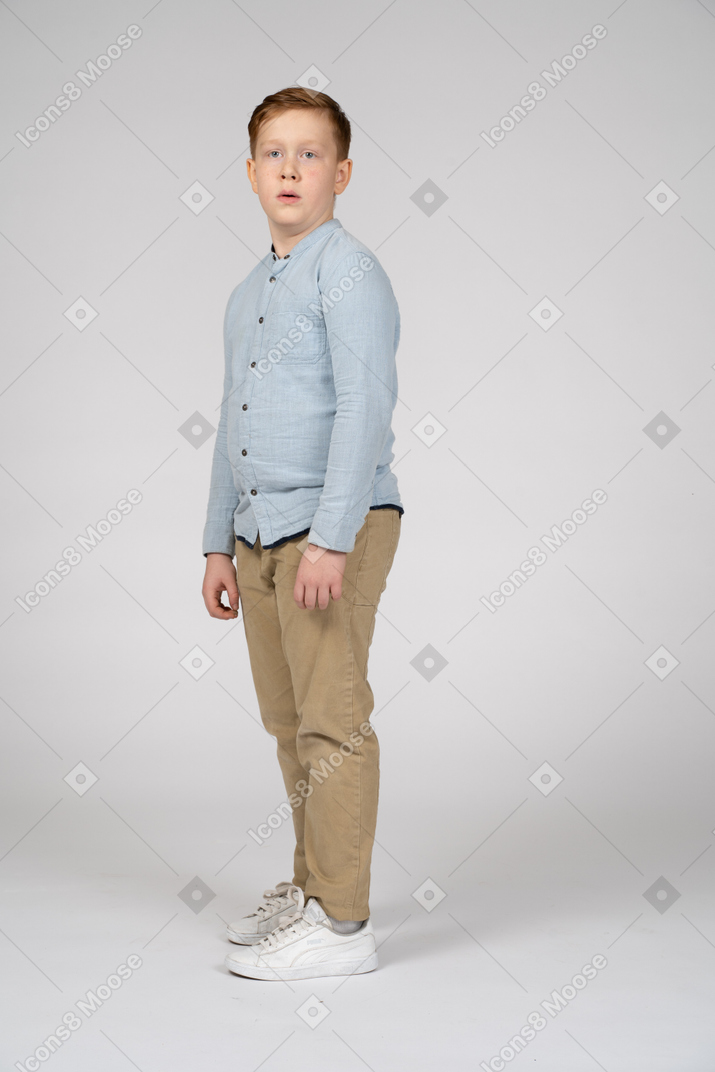 Side view of a boy looking at camera