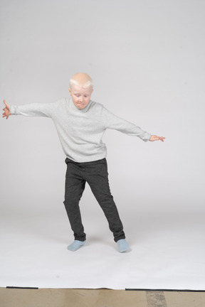 Boy jumping in the air with his arms spread