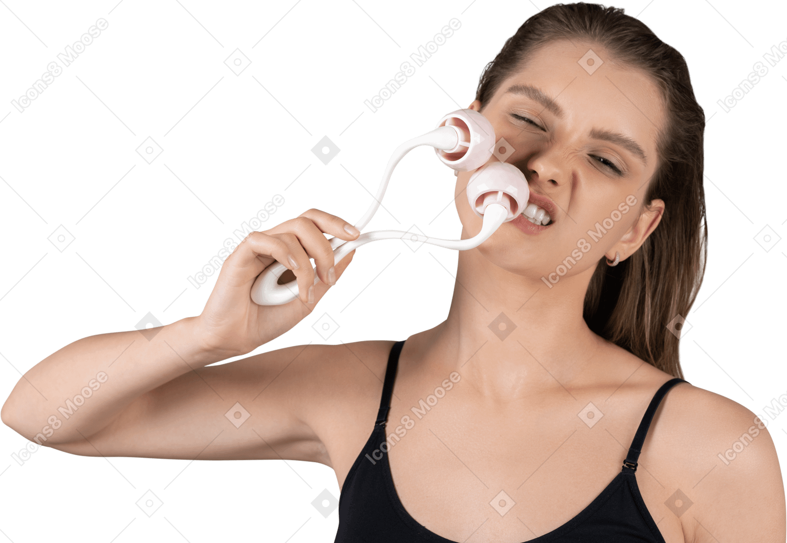 Front view of a young woman aggressively massaging her face with a face roller