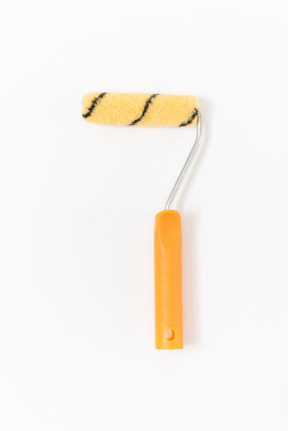 A striped paint roller with a bright orange handle lying on the plain white background
