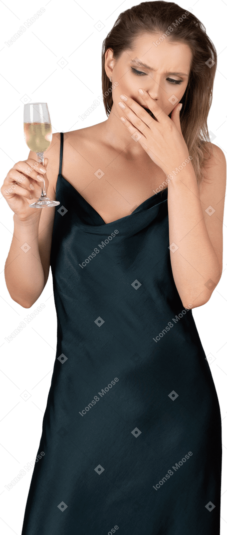 Front view of a young woman in night gown holding a glass of champagne