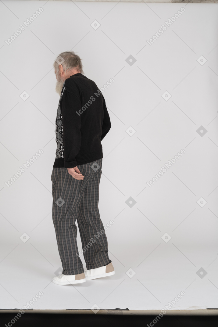 Back view of an elderly man walking away
