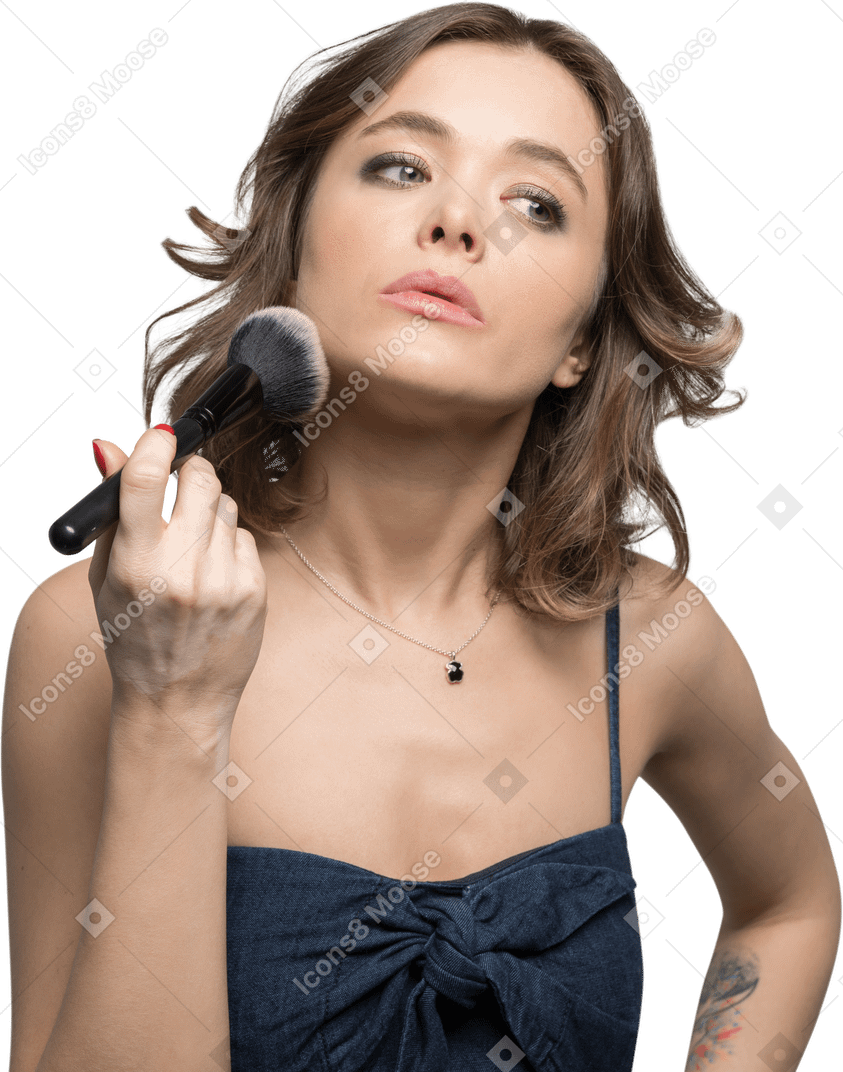 Pretty woman completing the look with a face powder
