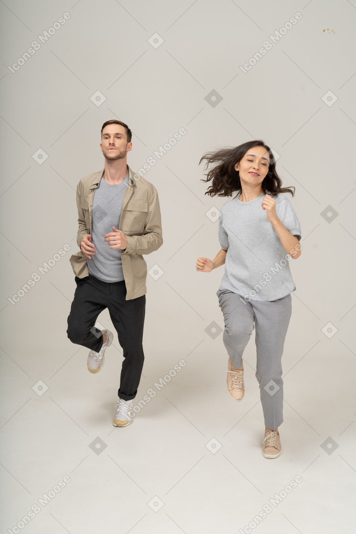 Young man and woman running toward the camera