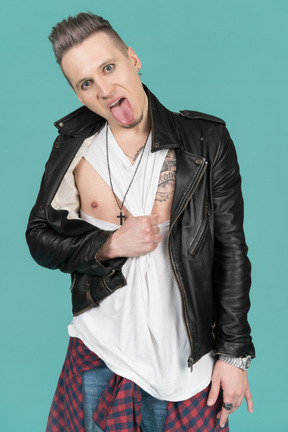 Young punk man showing his tongue