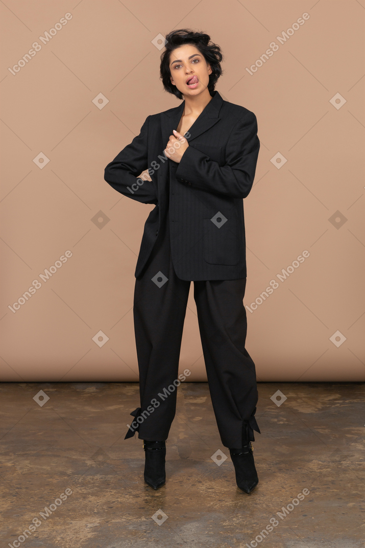 A woman in a black suit posing for a picture