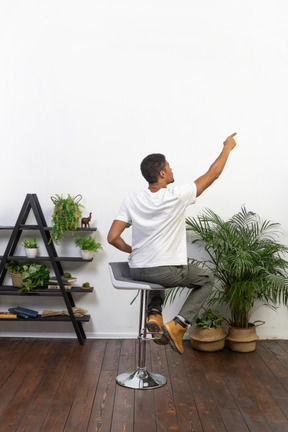 Good looking young man sitting on a chair