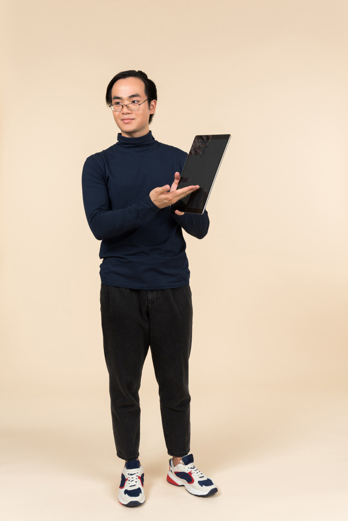 Young asian man presenting a digital tablet