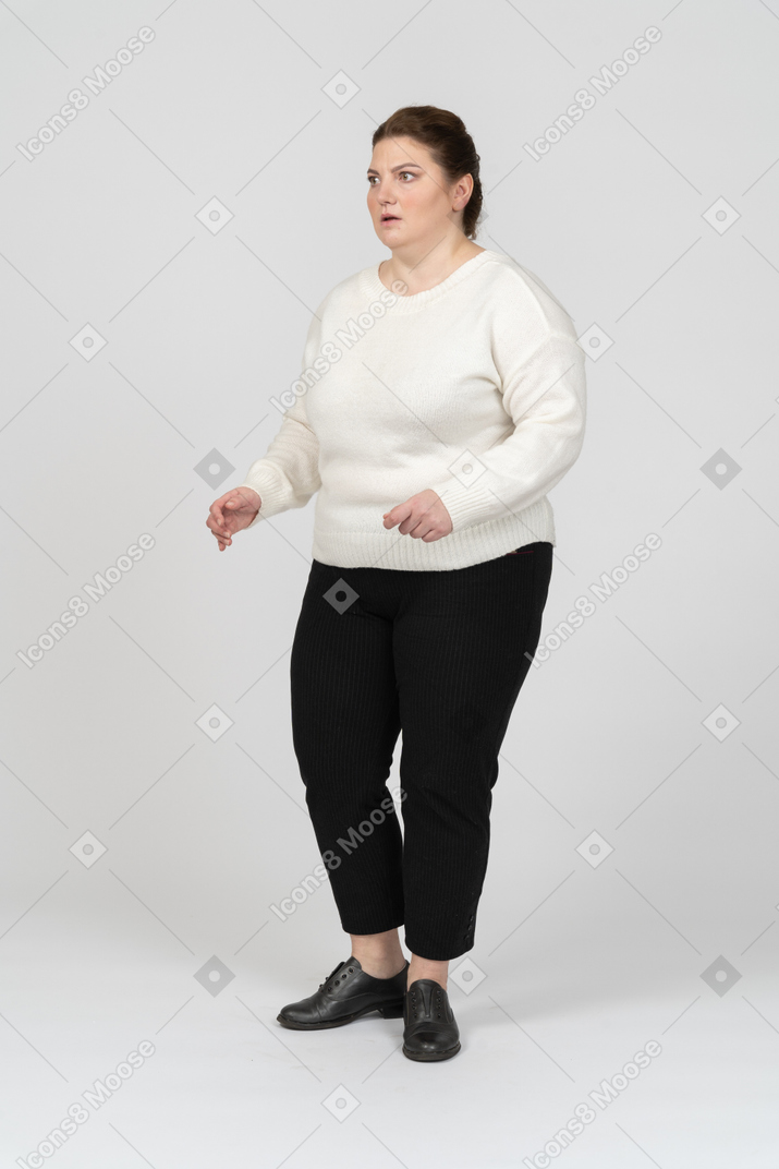 Surprised plump woman in white sweater