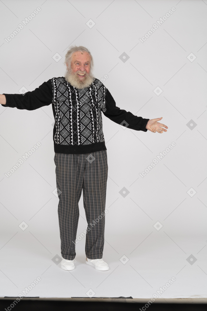 Front view of delighted elderly man standing with open arms