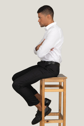 Good looking young man sitting on the chair