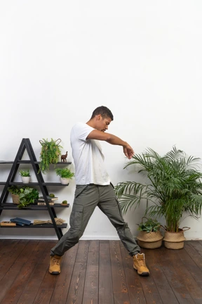 Handsome athletic man posing on the background of the apartment