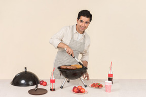 Young caucasian man preparing bbq