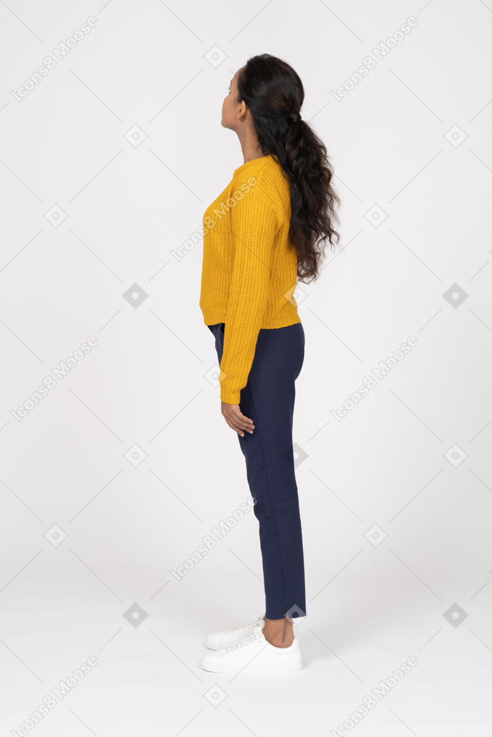 Side view of a girl in casual clothes looking up