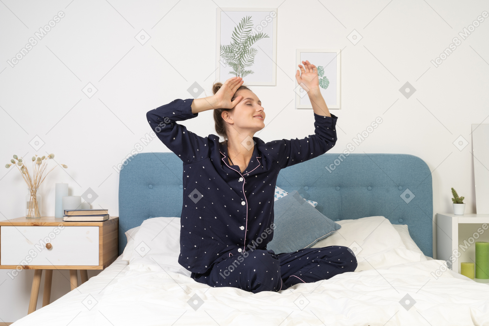Front view of a young lady in pajamas waking up & staying in bed
