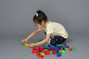 Little girl playing with building blocks