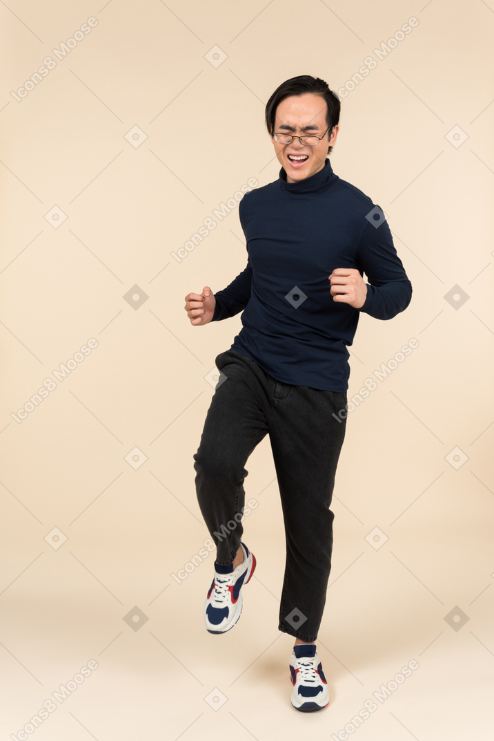 Young asian man screaming in excitement