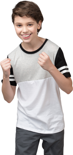 Boy showing off his fists and smiling