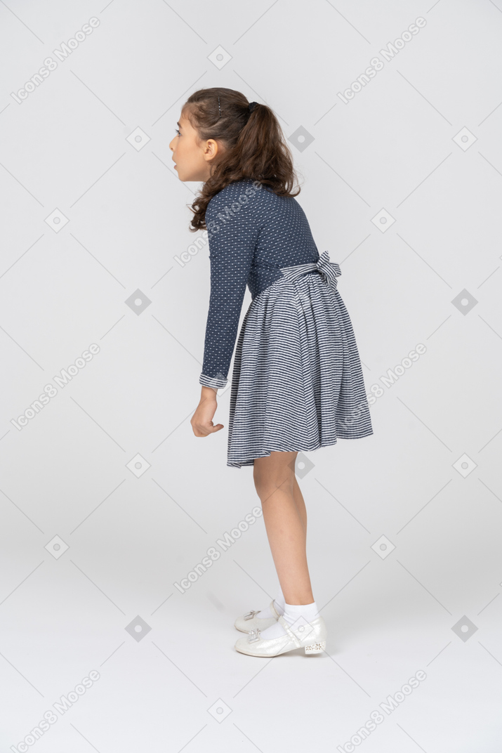 Three-quarter back view of a girl leaning forward