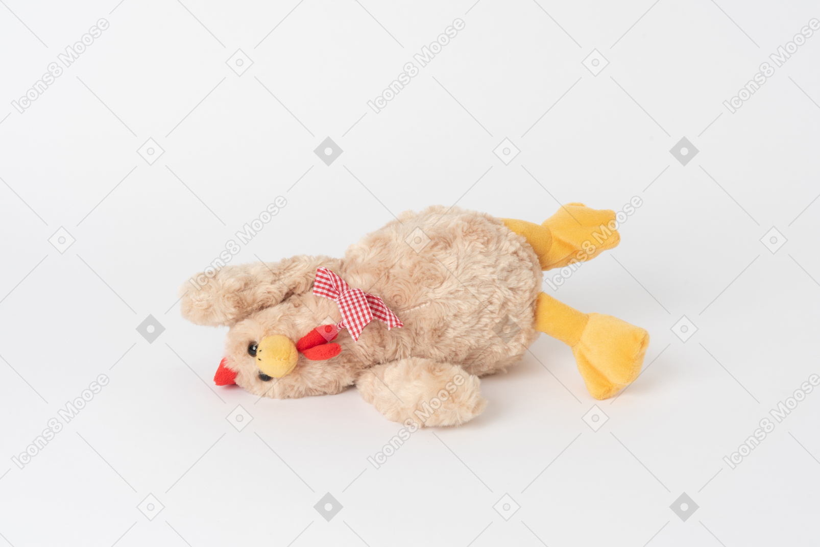 A plush chicken toy lying isolated against a plain white background