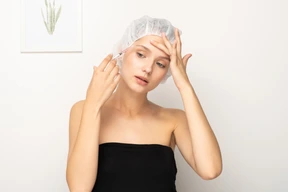 Woman making injection to her forehead