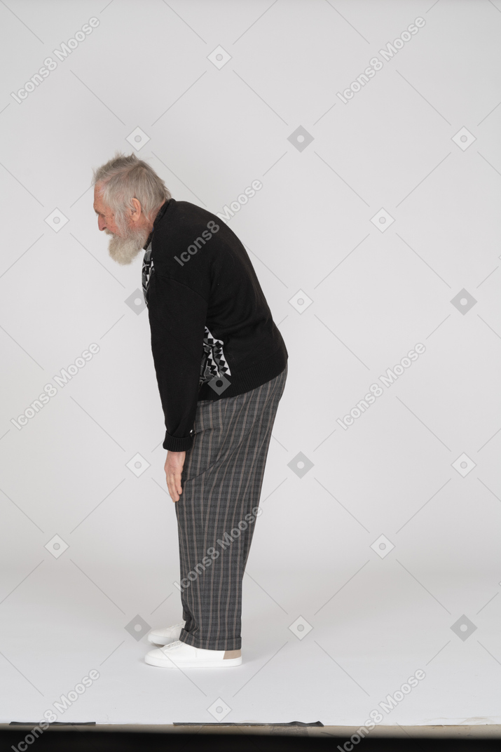 Side view of groaning old man feeling pain in leg