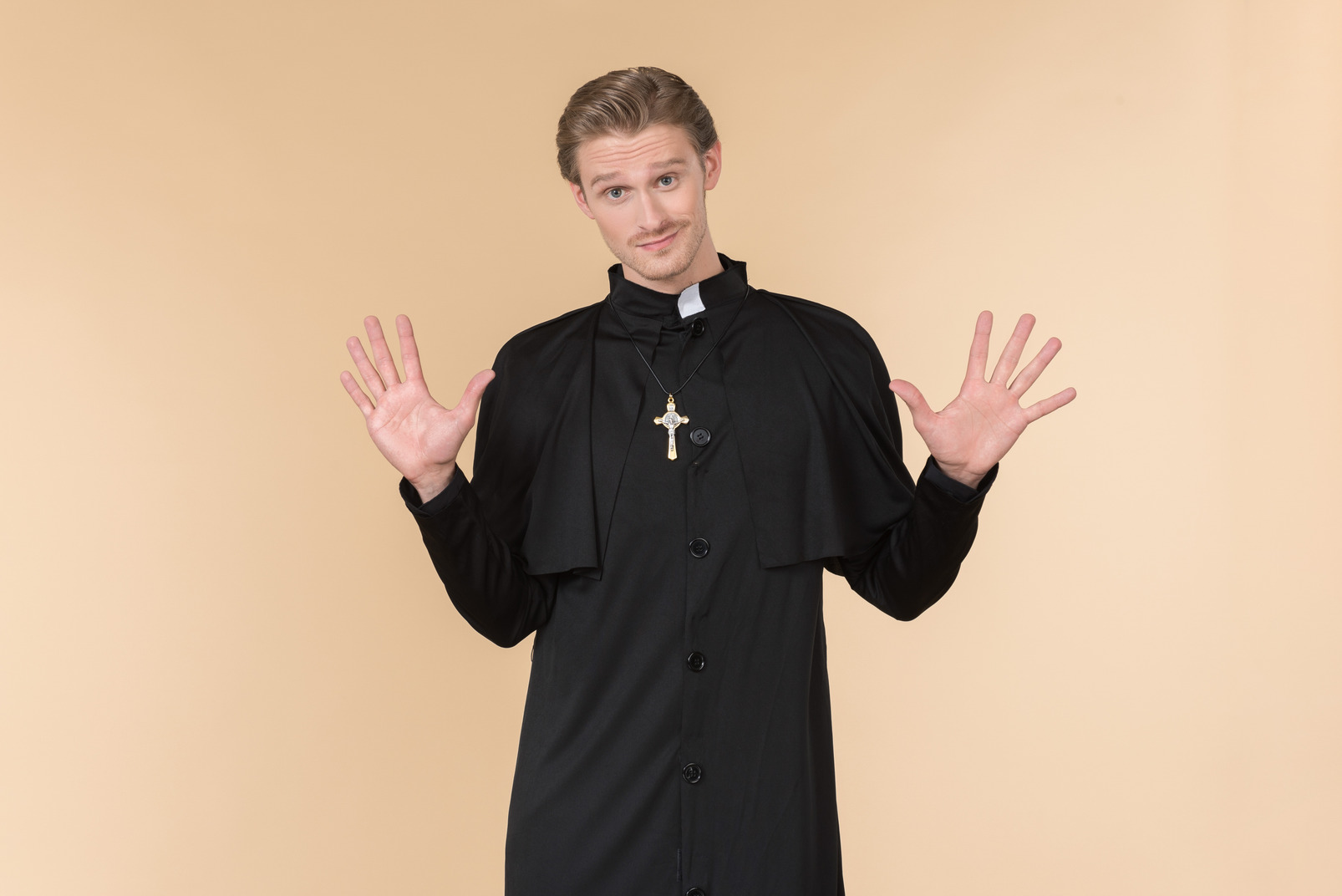 Catholic priest standing with hands aside